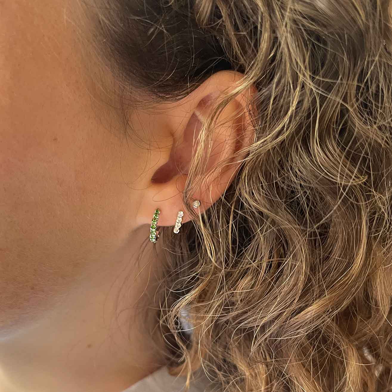 model with silver emerald hoop ear stud