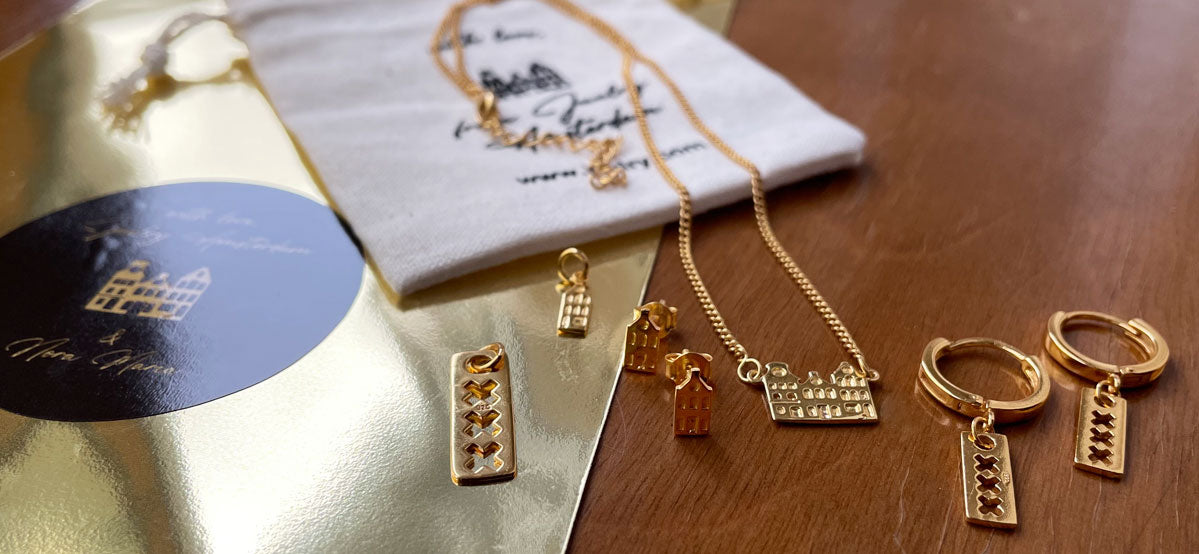 selection of Amsterdam jewelry, like canalhouse pendant and necklace. Everything gold plated.