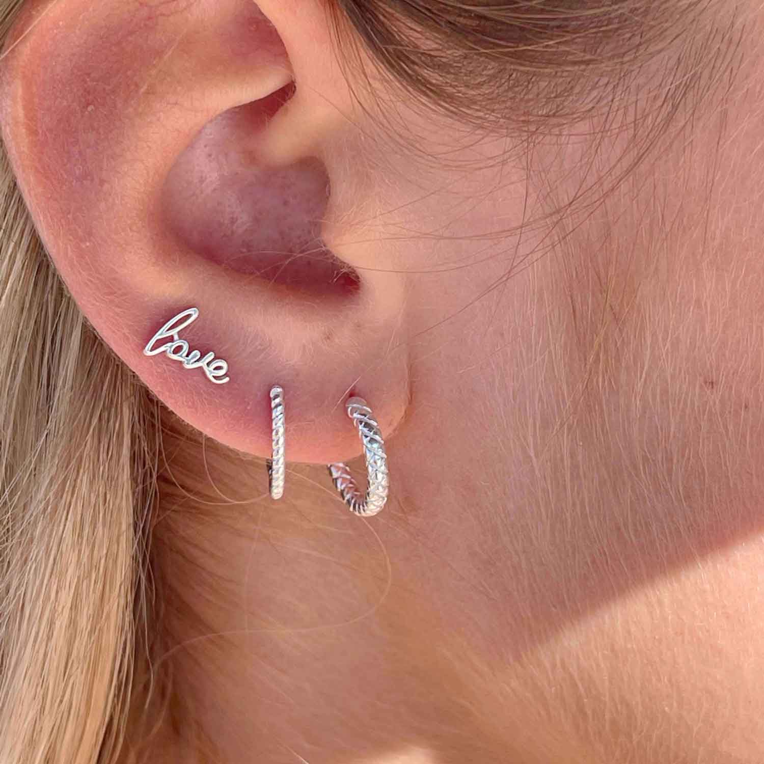 model with love ear stud silver