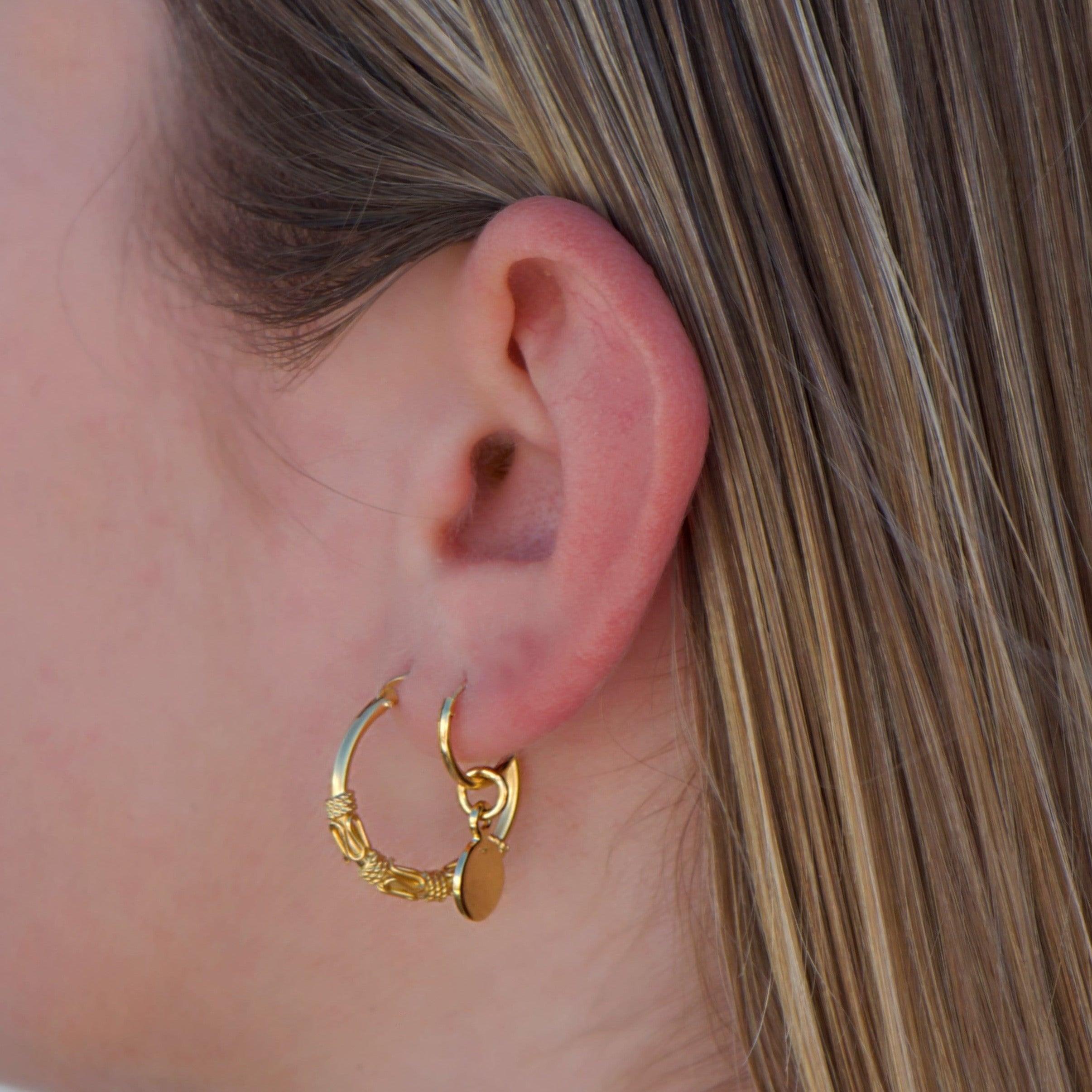 model with 12 mm hoop earrings with round pendant