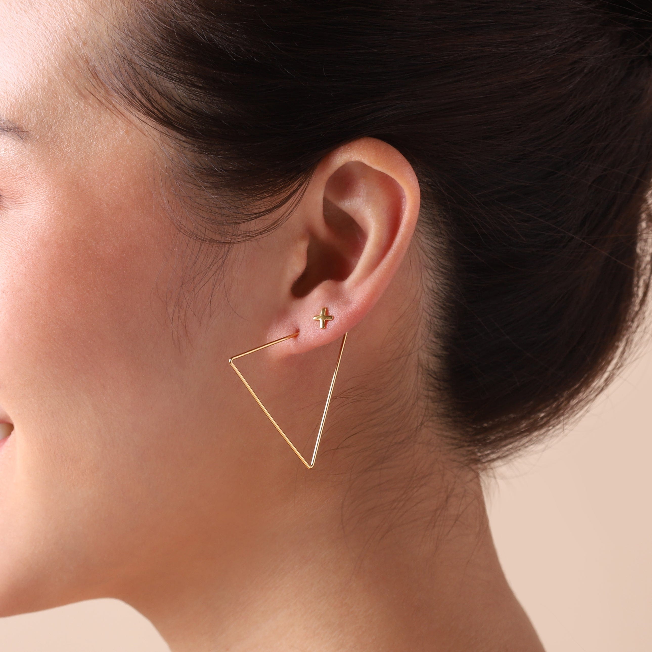 gold plated cross stud earrings on model