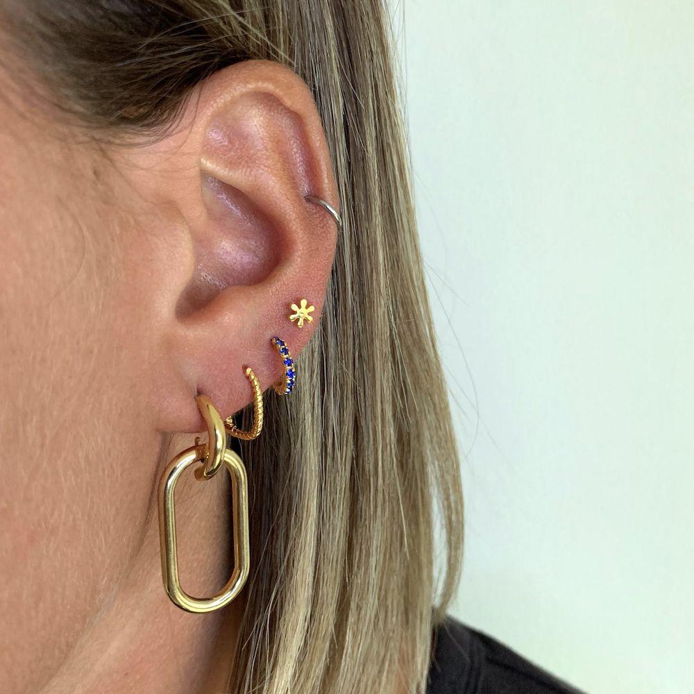 model with gold plated oval earrings