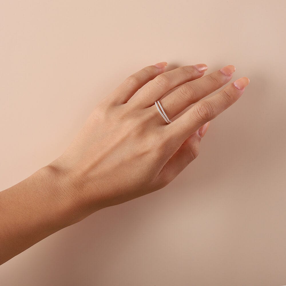 pair of braided silver rings on model