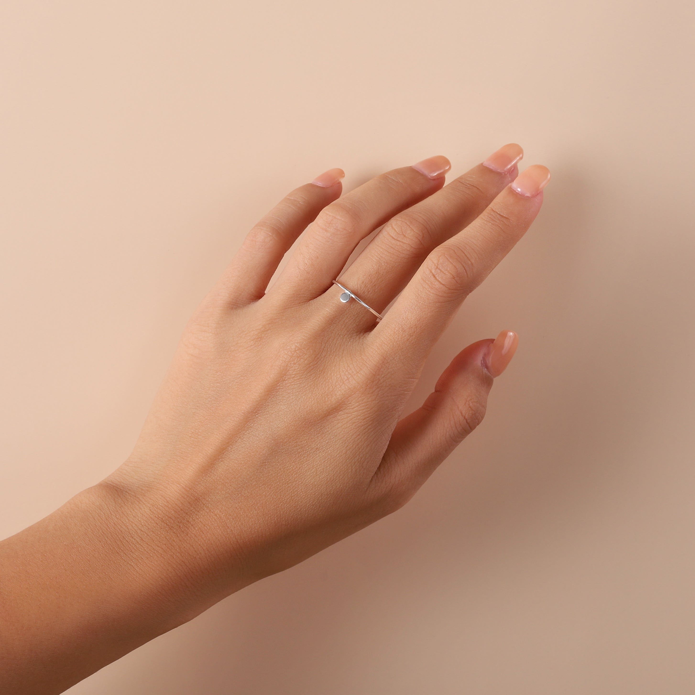 silver floated round ring on hand model