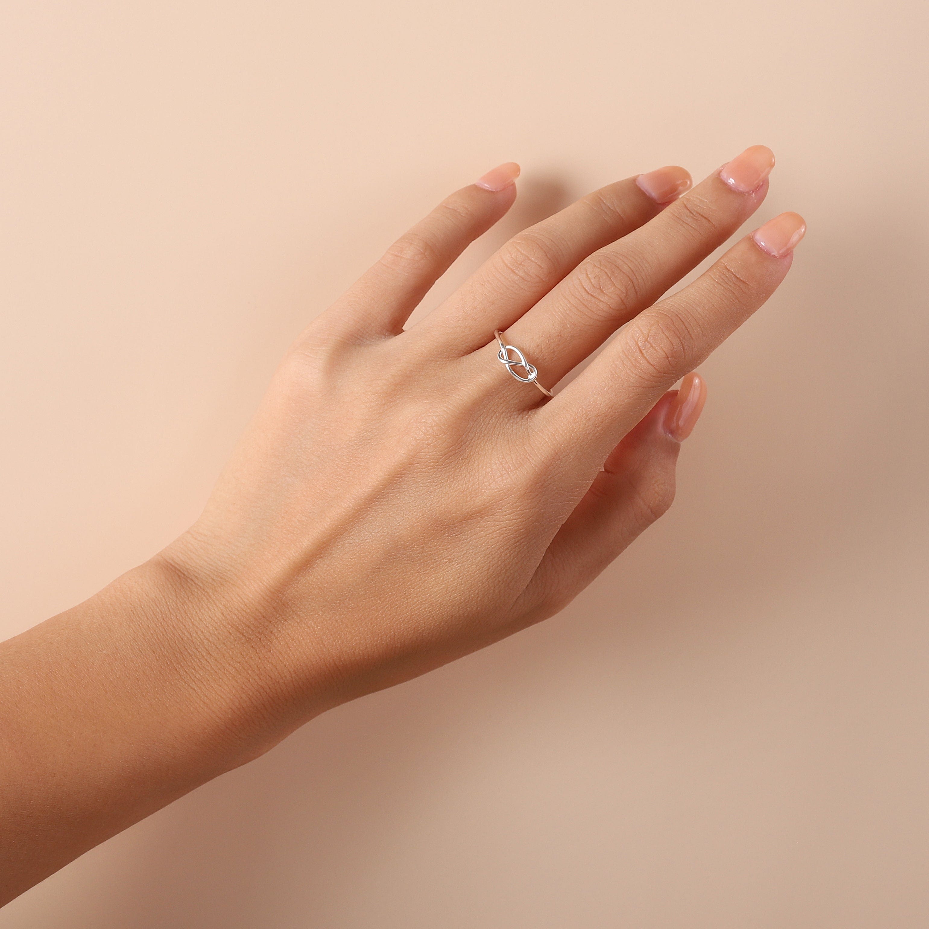 silver knot ring on model