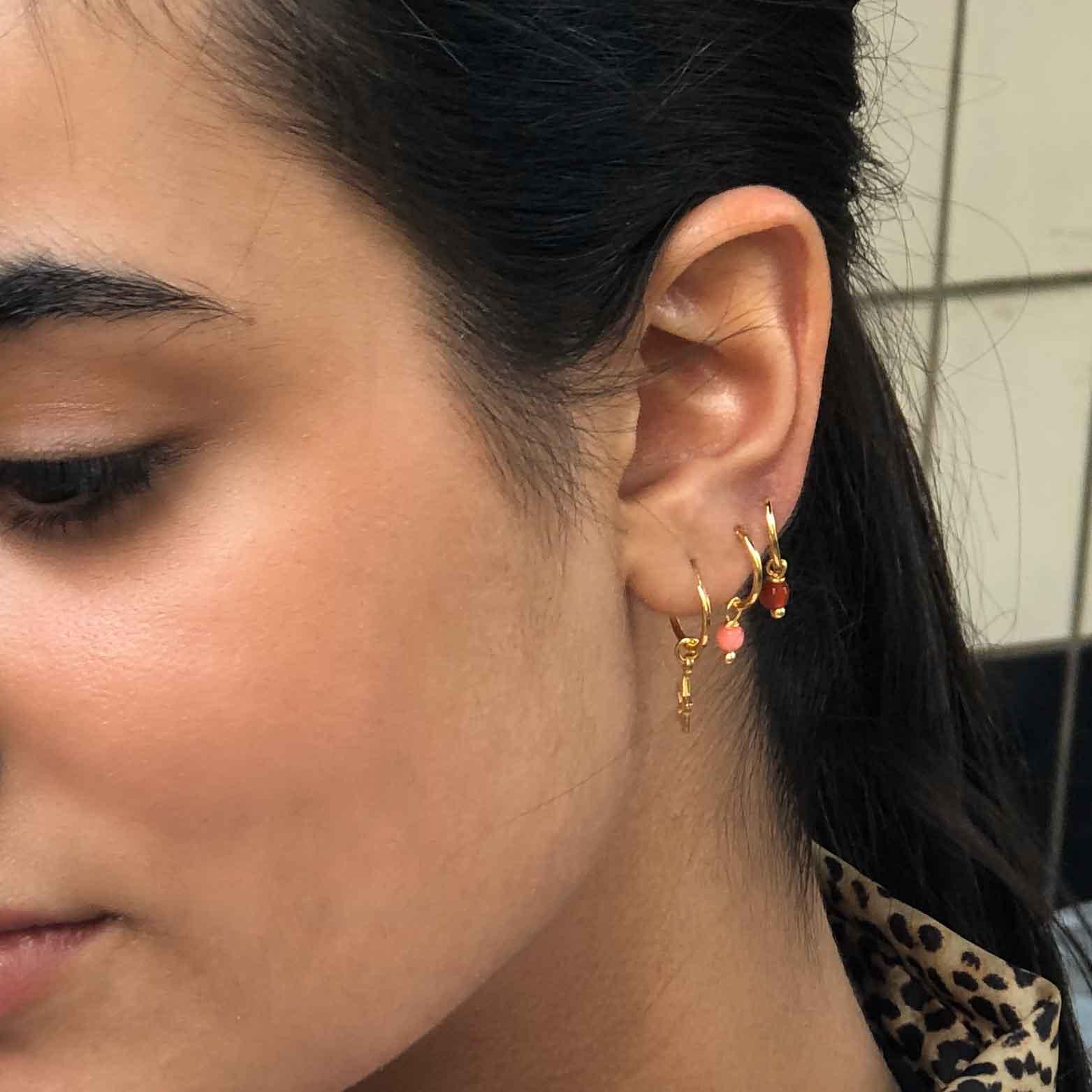 model with Small Gold Plated Hoop Earrings with Pink Stone