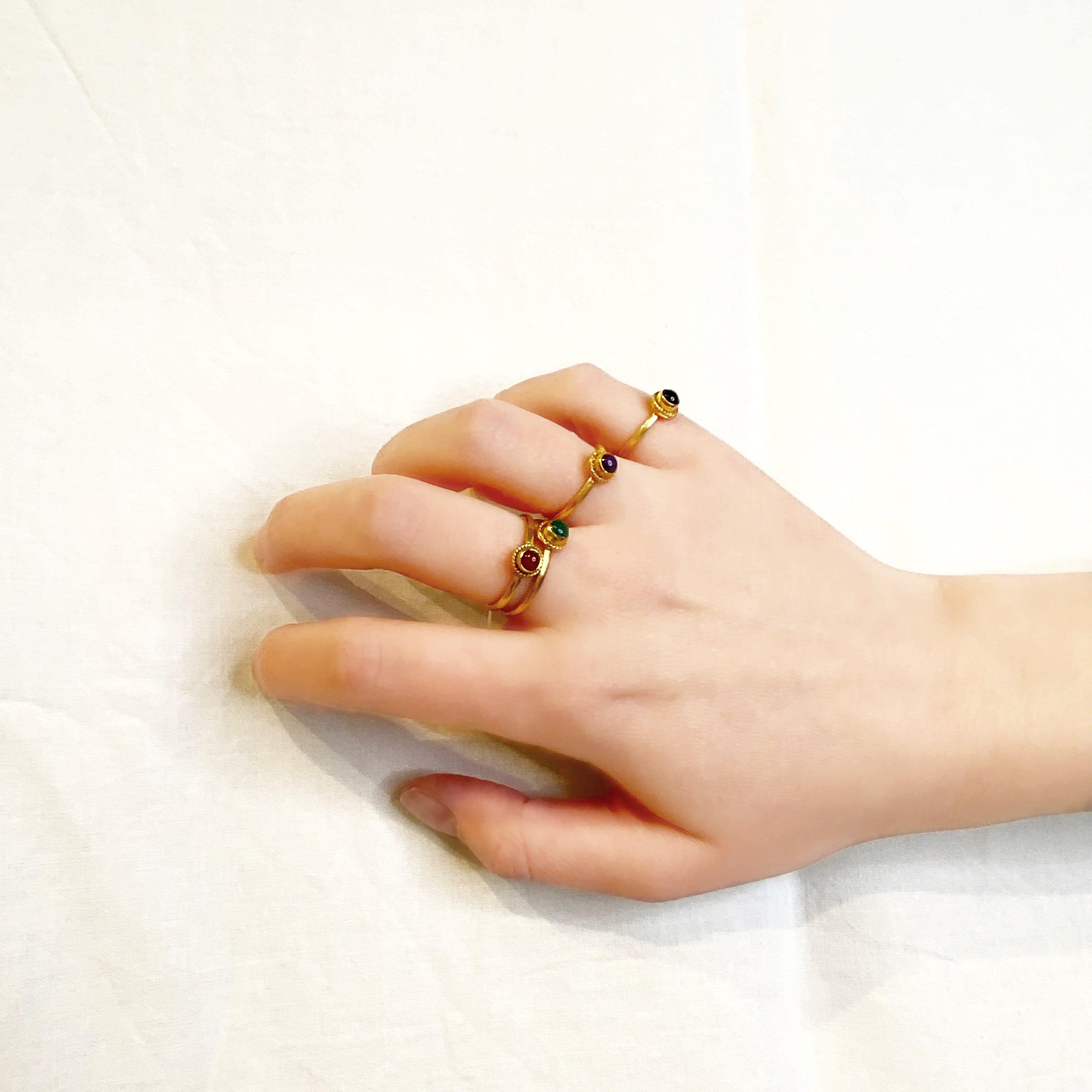 gold plated braided ring with green onyx on hand model