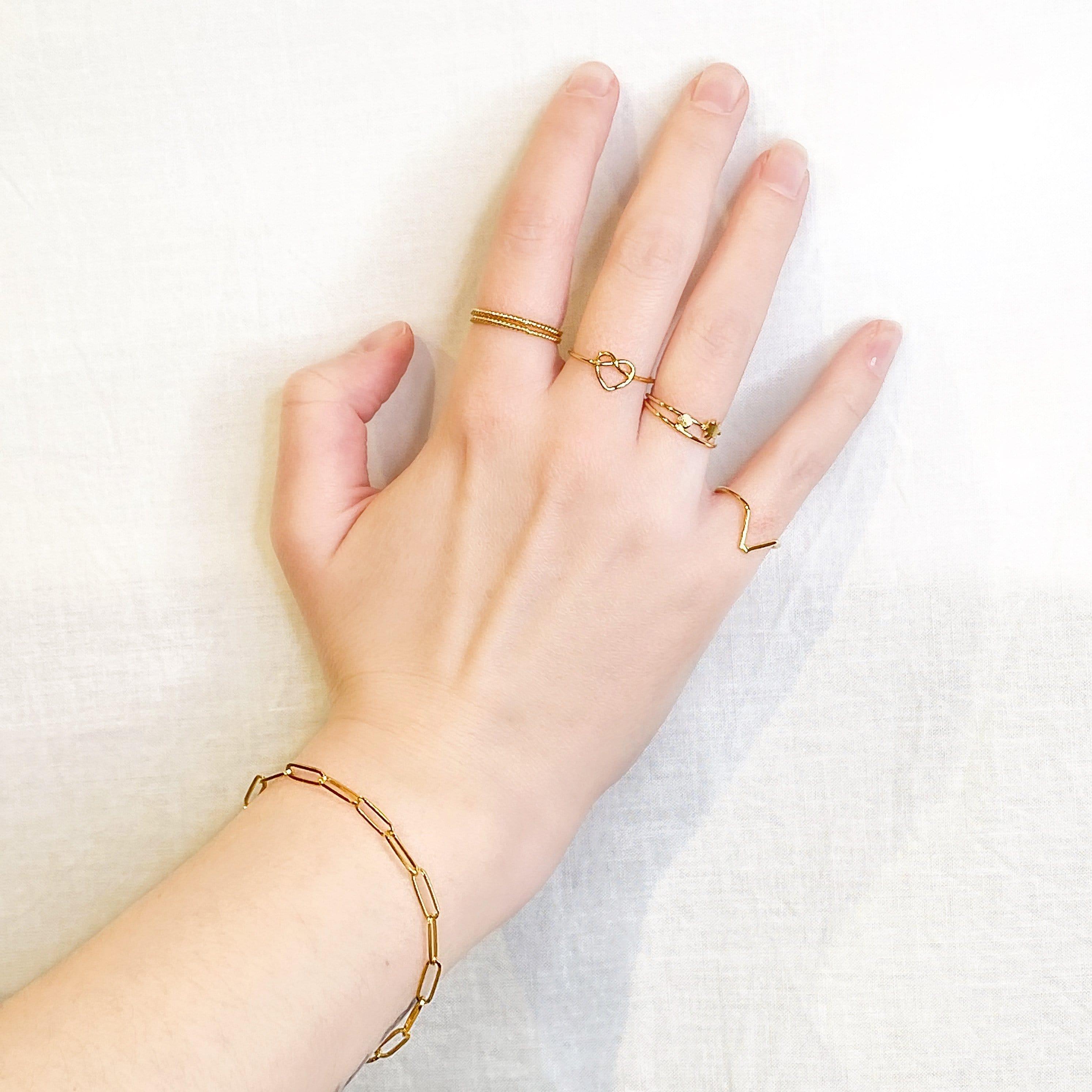 gold plated braided heart ring on hand model