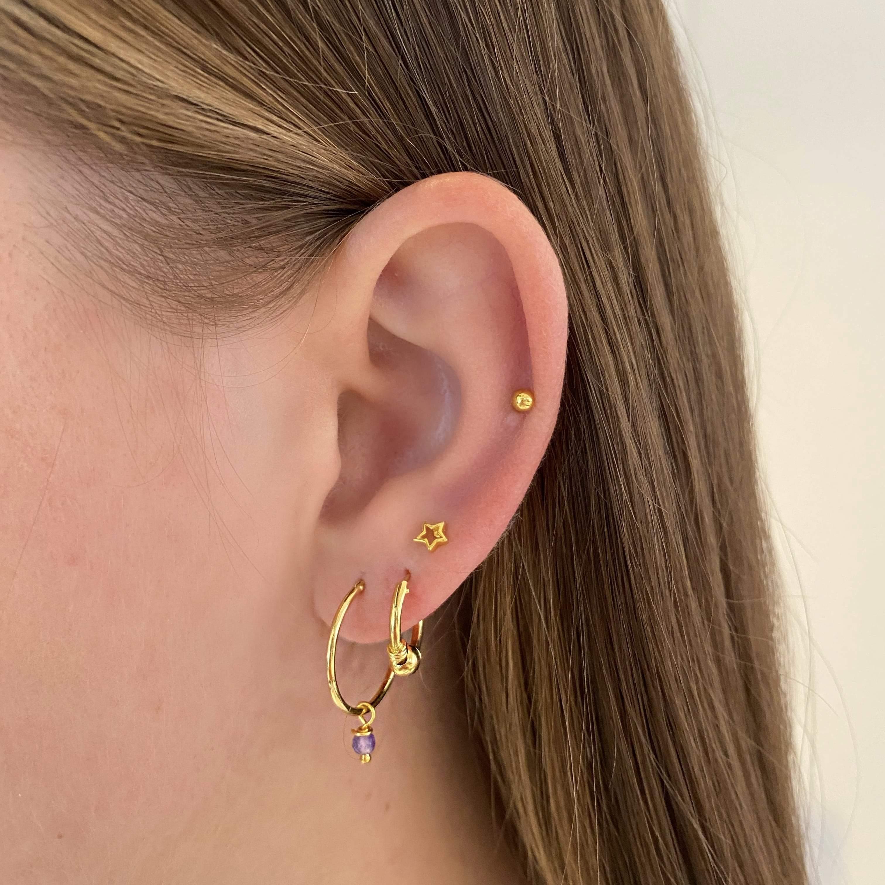 model with 18mm Gold Plated Hoop Earrings with Purple Stone