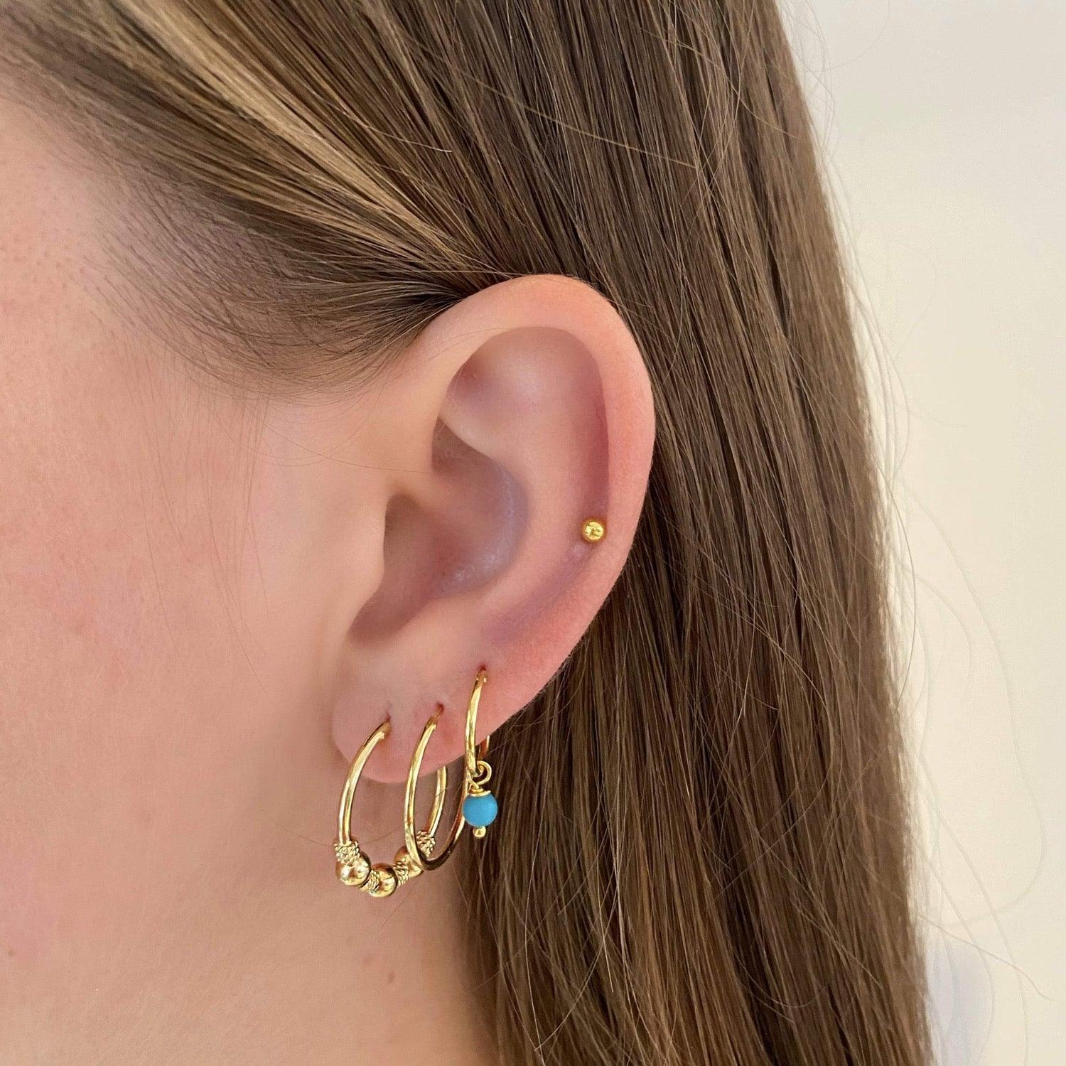 model with Gold plated Bali Hoop Earrings Changgu with three balls
