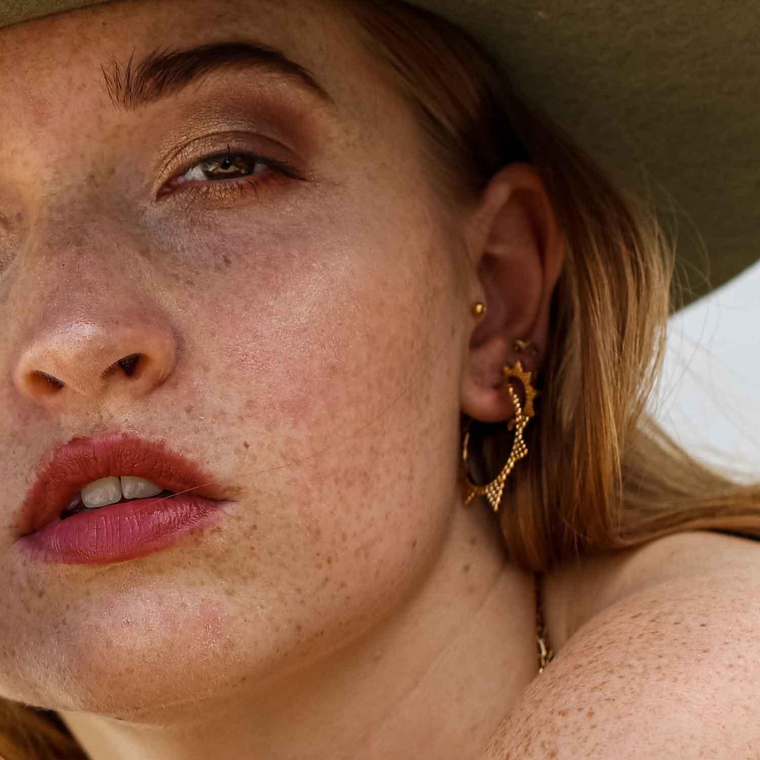 model with Gold Plated Indian Star Hoop Earrings