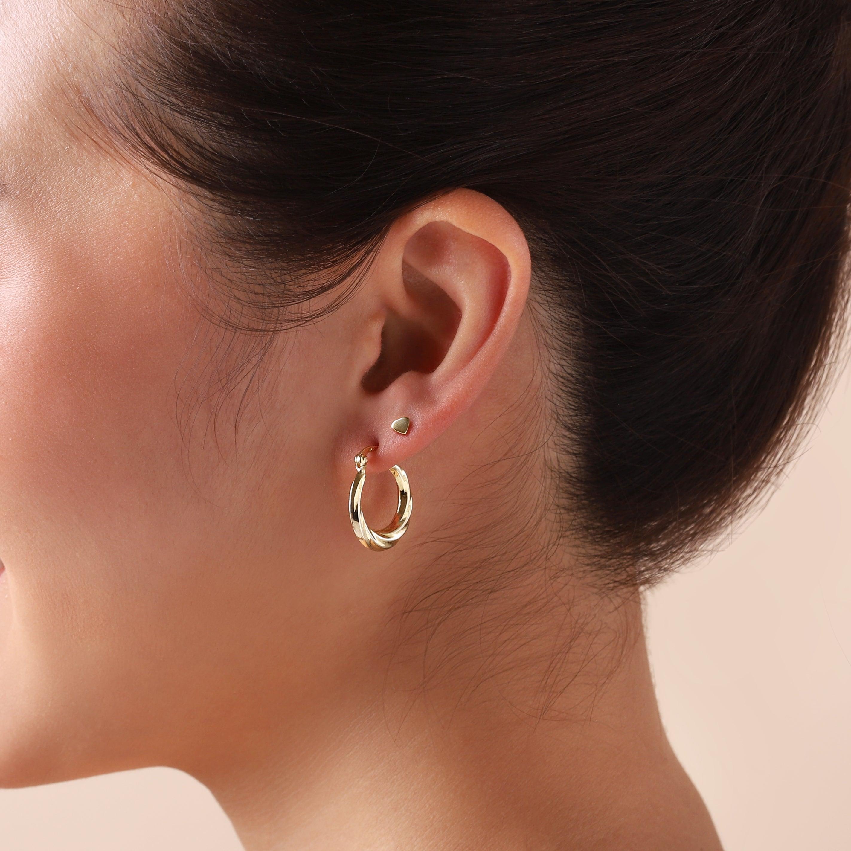 gold plated twisted hoop earrings on model