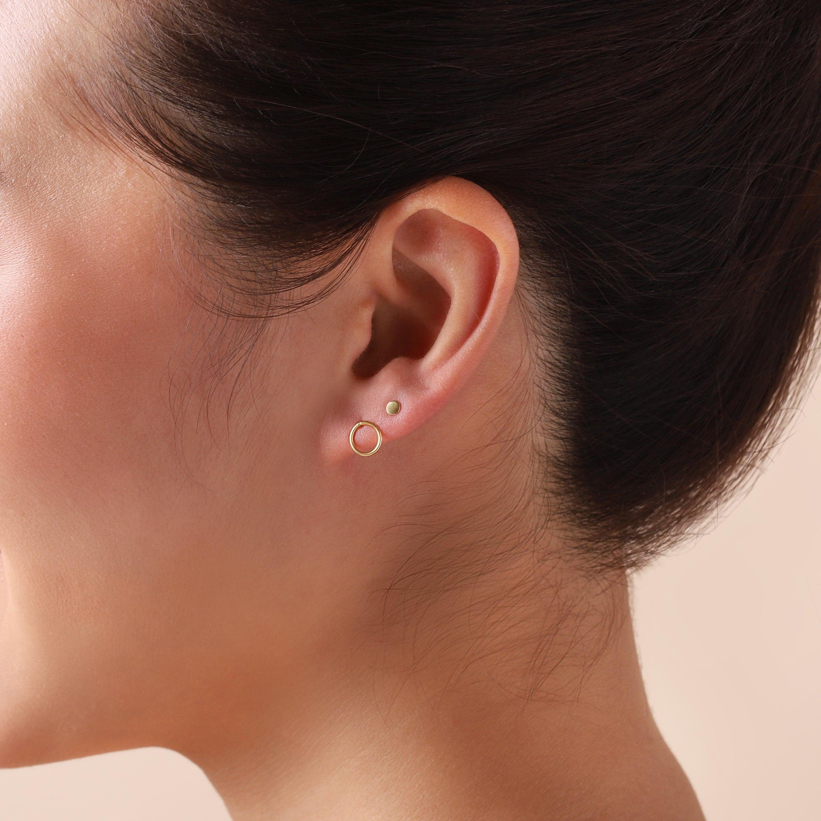 gold mini stud earrings 3 mm on model