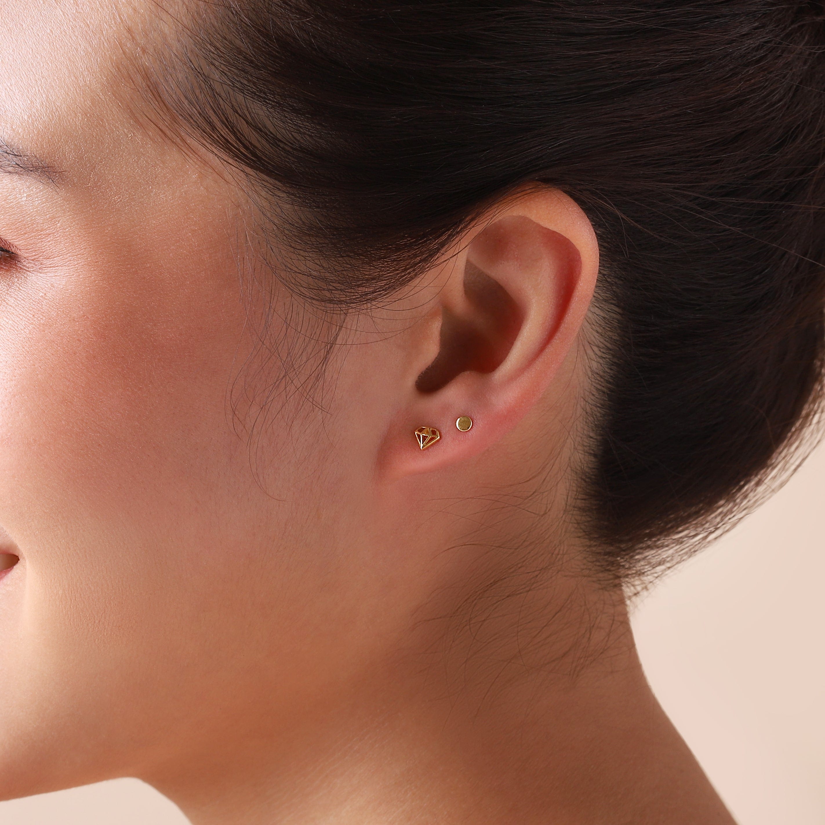 gold mini stud earrings 3mm on model
