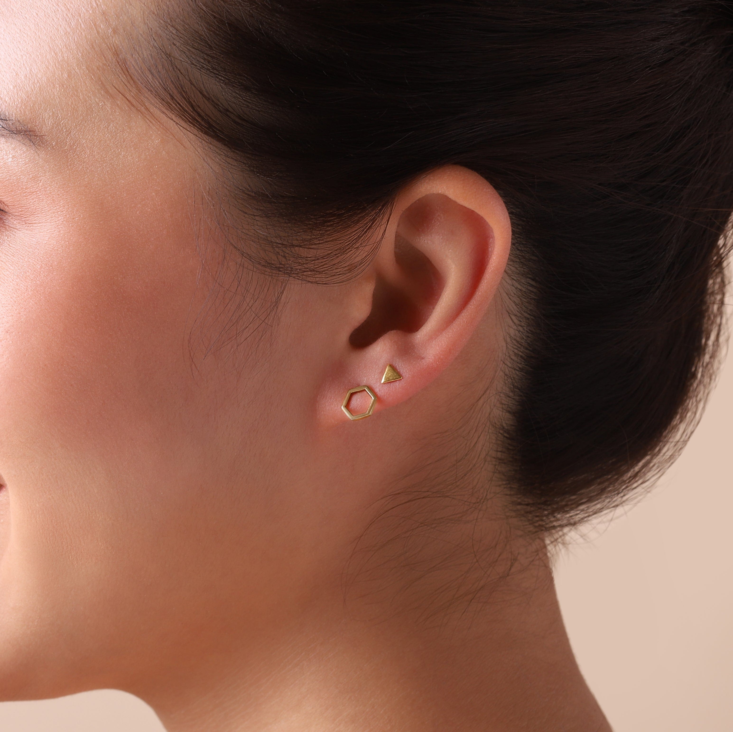 gold plated triangle stud earrings on model