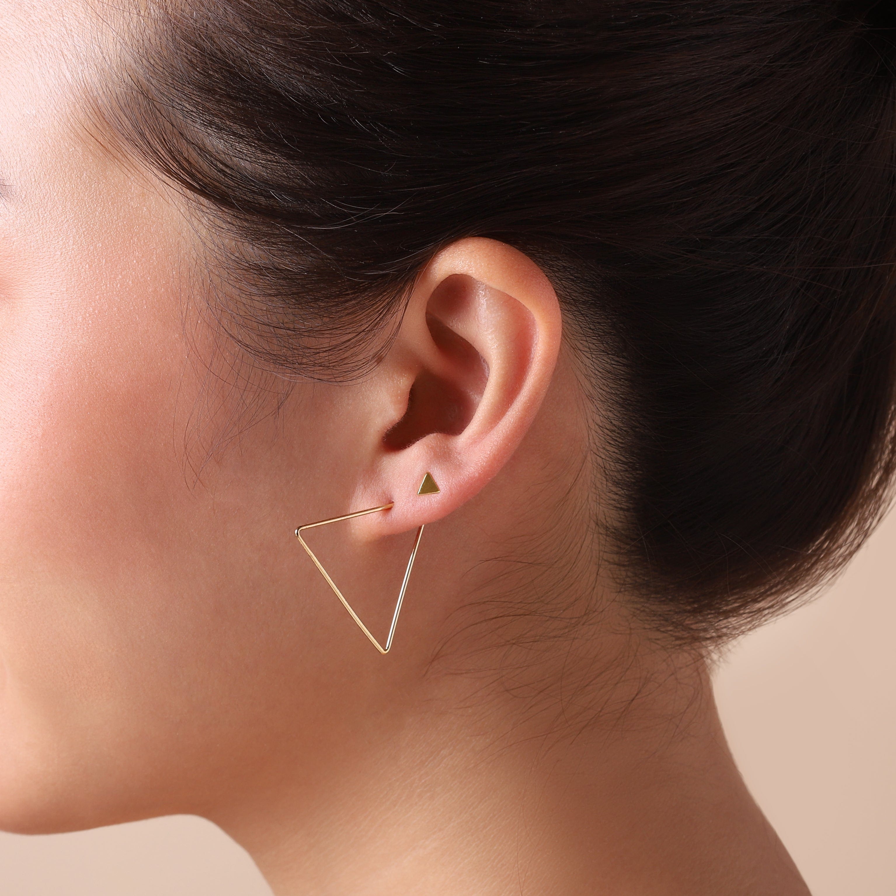 gold plated triangle stud earrings on model