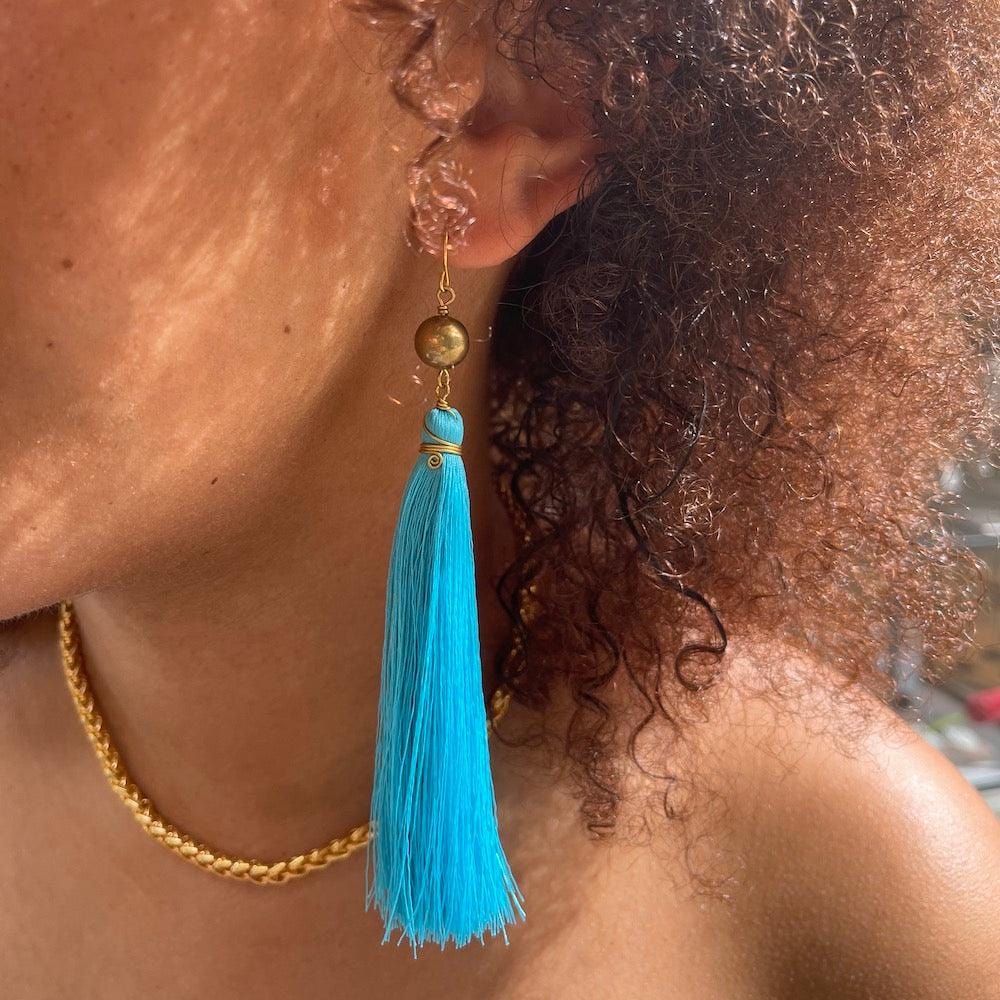 model with turquoise brush earrings