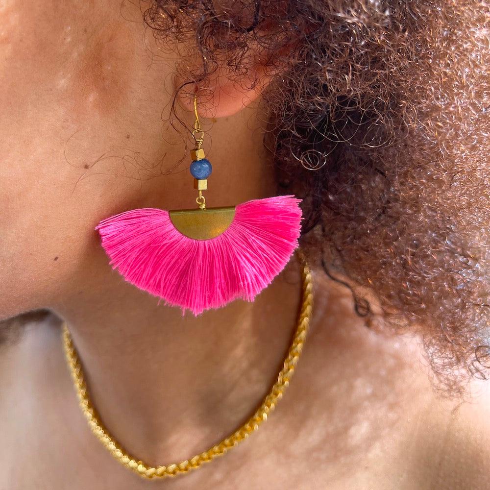 model with pink fan earrings