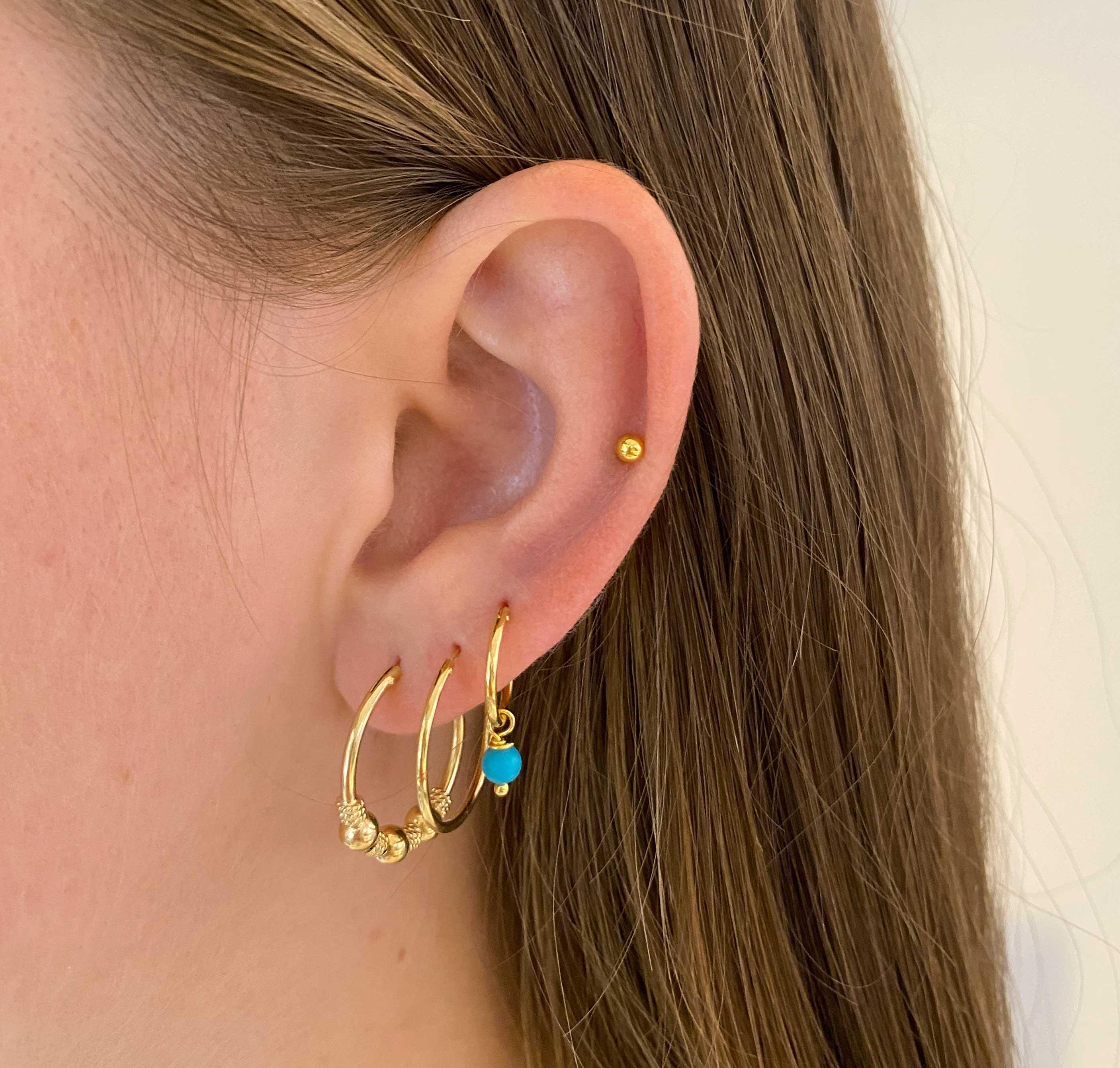 model with Small Gold Plated Hoop Earrings with Turquoise Blue Stone