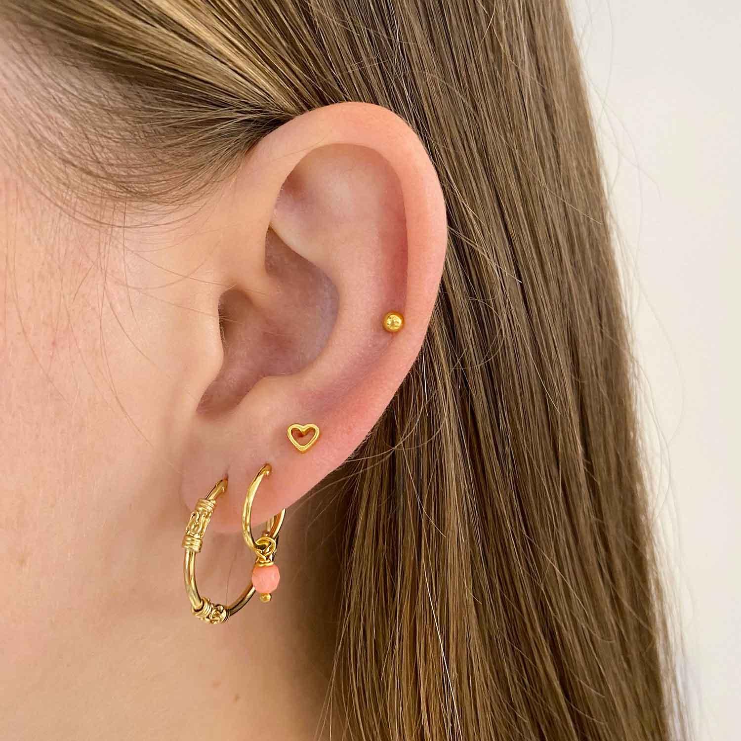 girl with open heart ear stud gold plated
