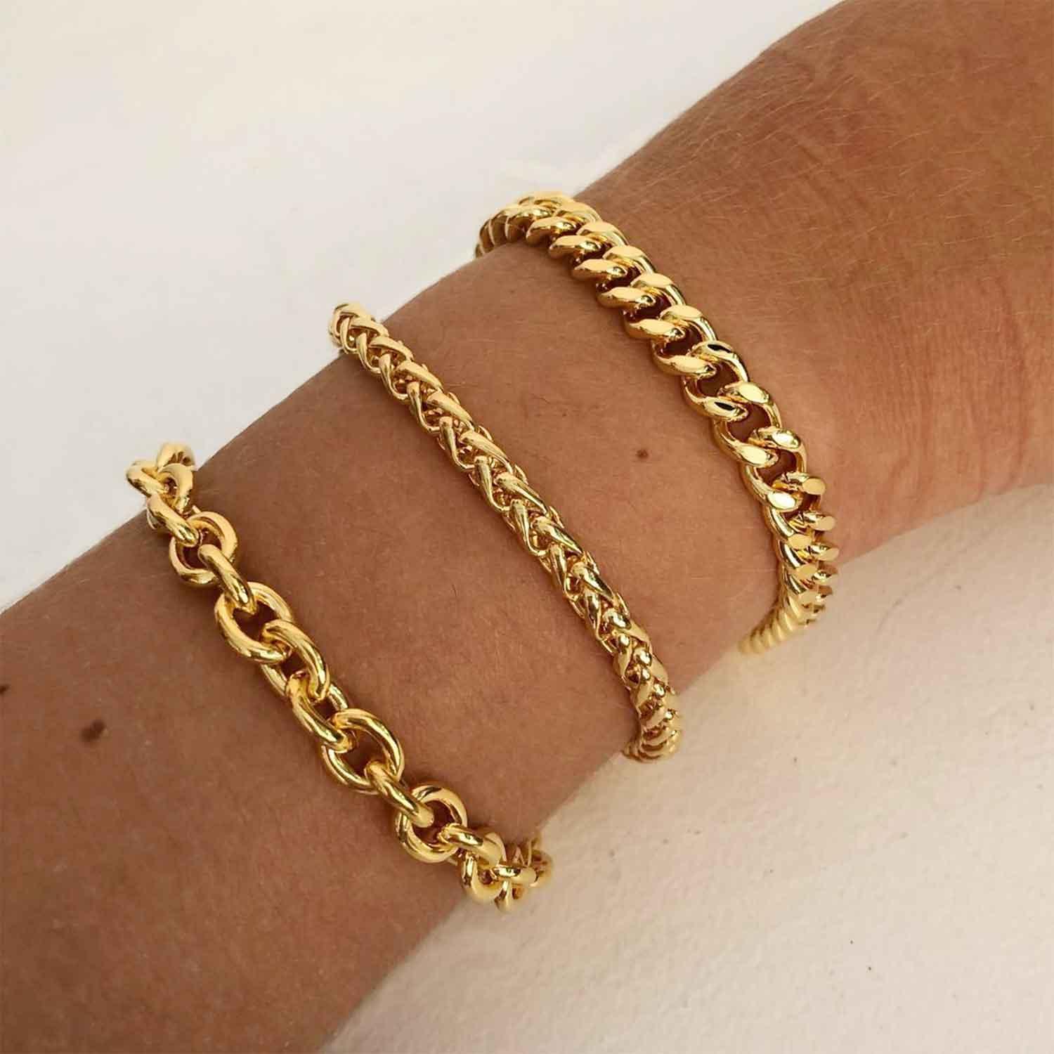 arm with gold plated chunky bracelets