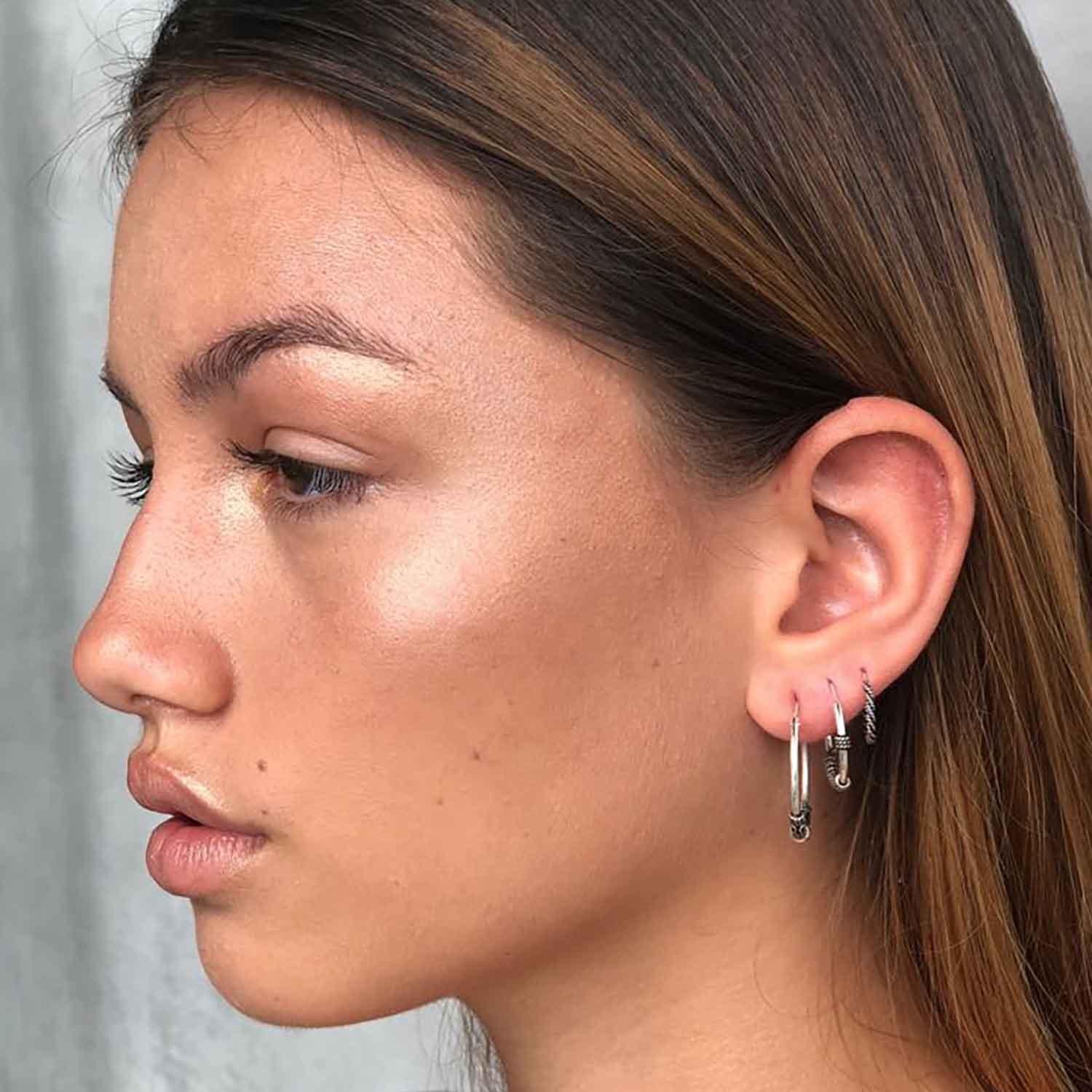 model with traditional silver Bali hoops with ball