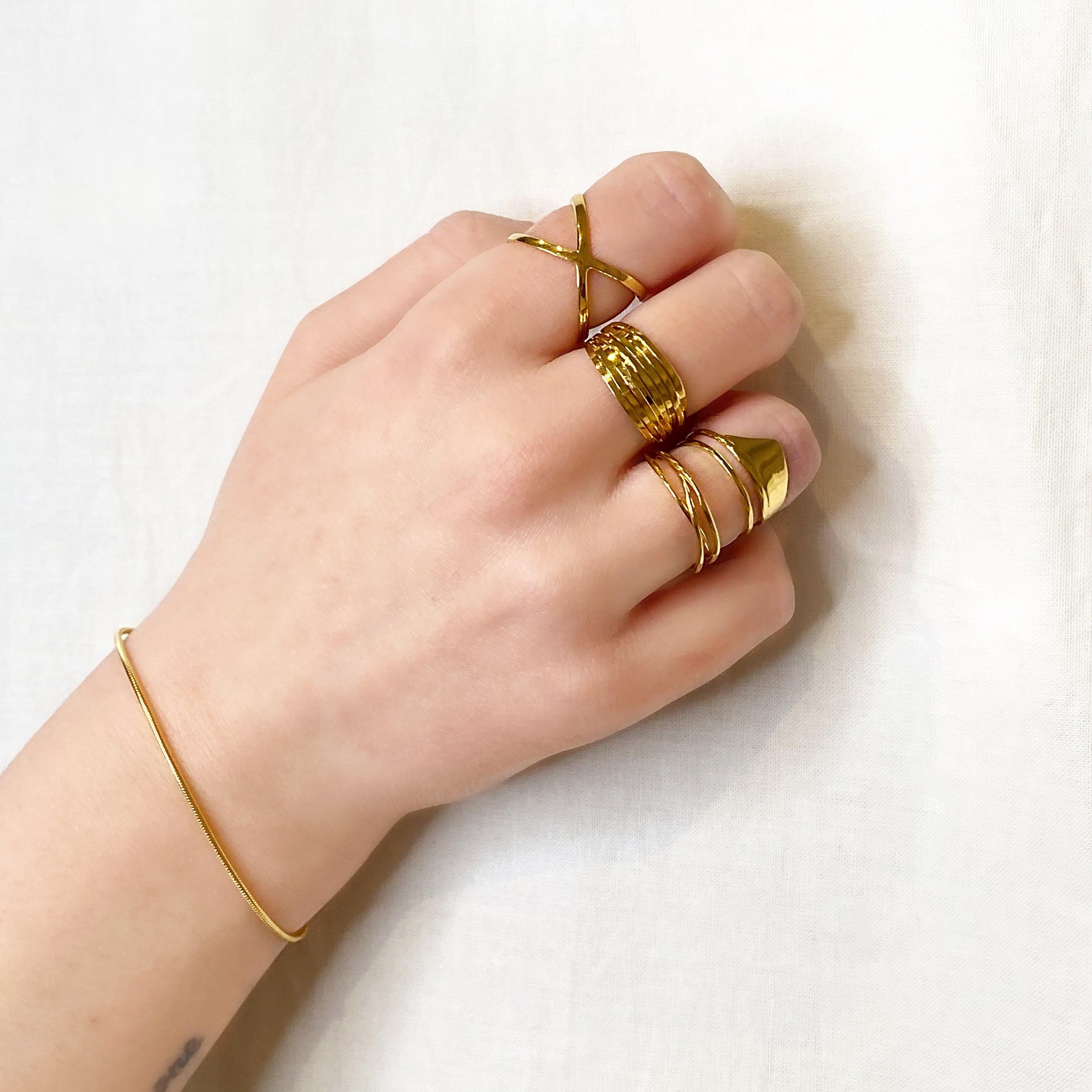 gold plated set of three rings on hand model