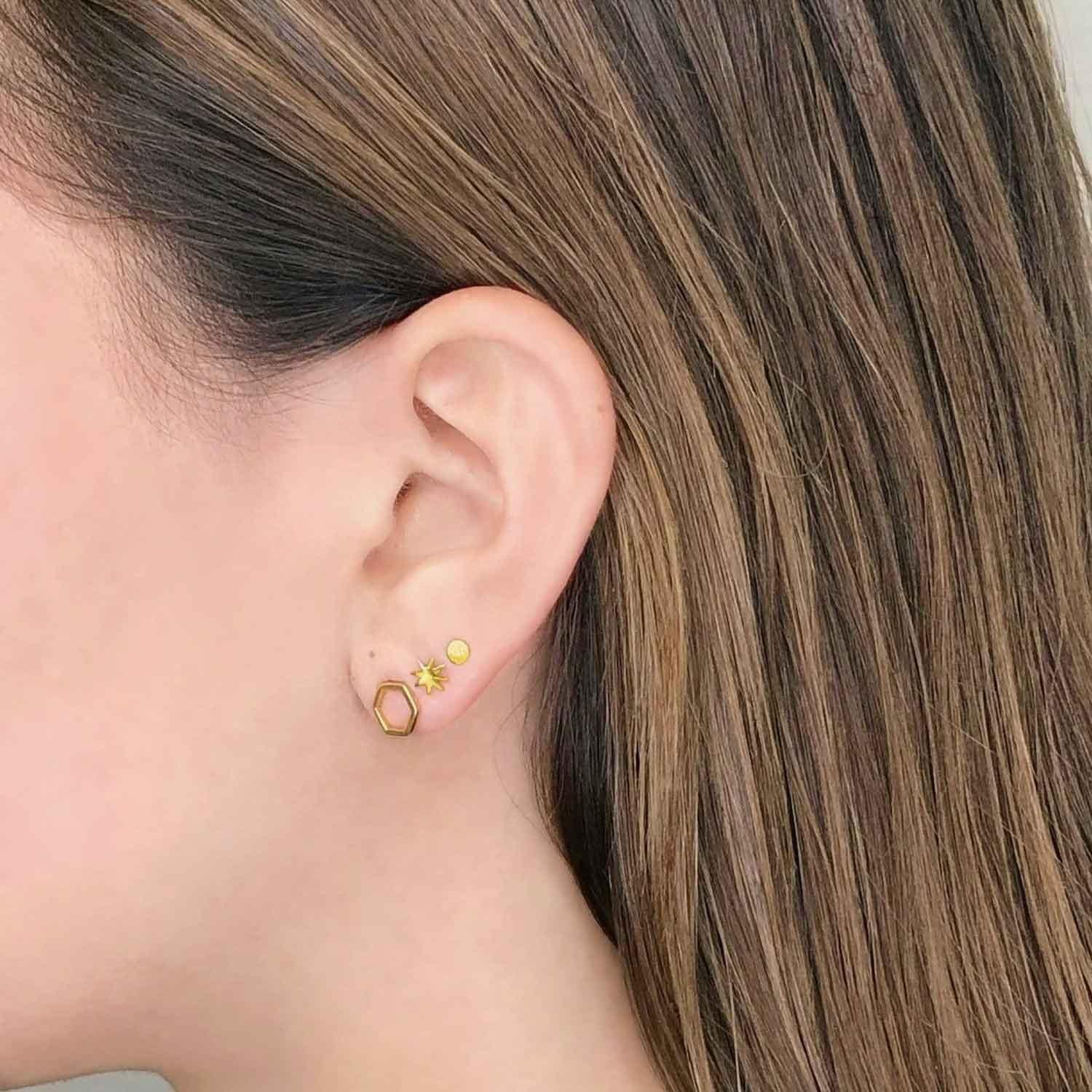 girl with gold plated stud earrings hexagon