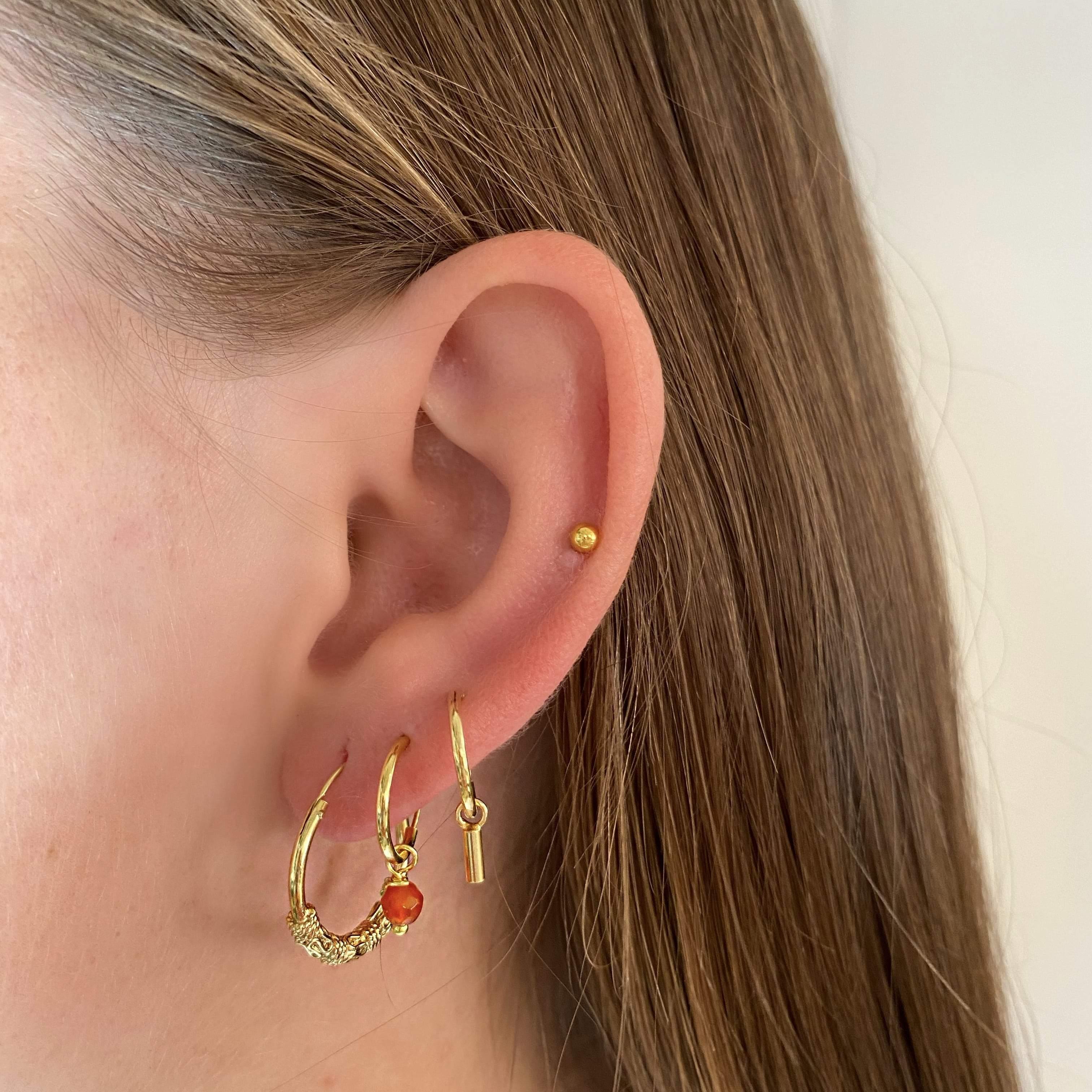model with 12mm Gold Plated Hoop Earrings with Red Stone