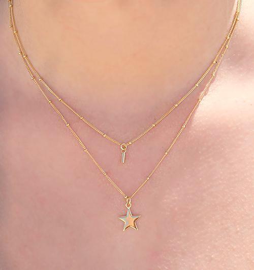 gold plated necklace with rod on model