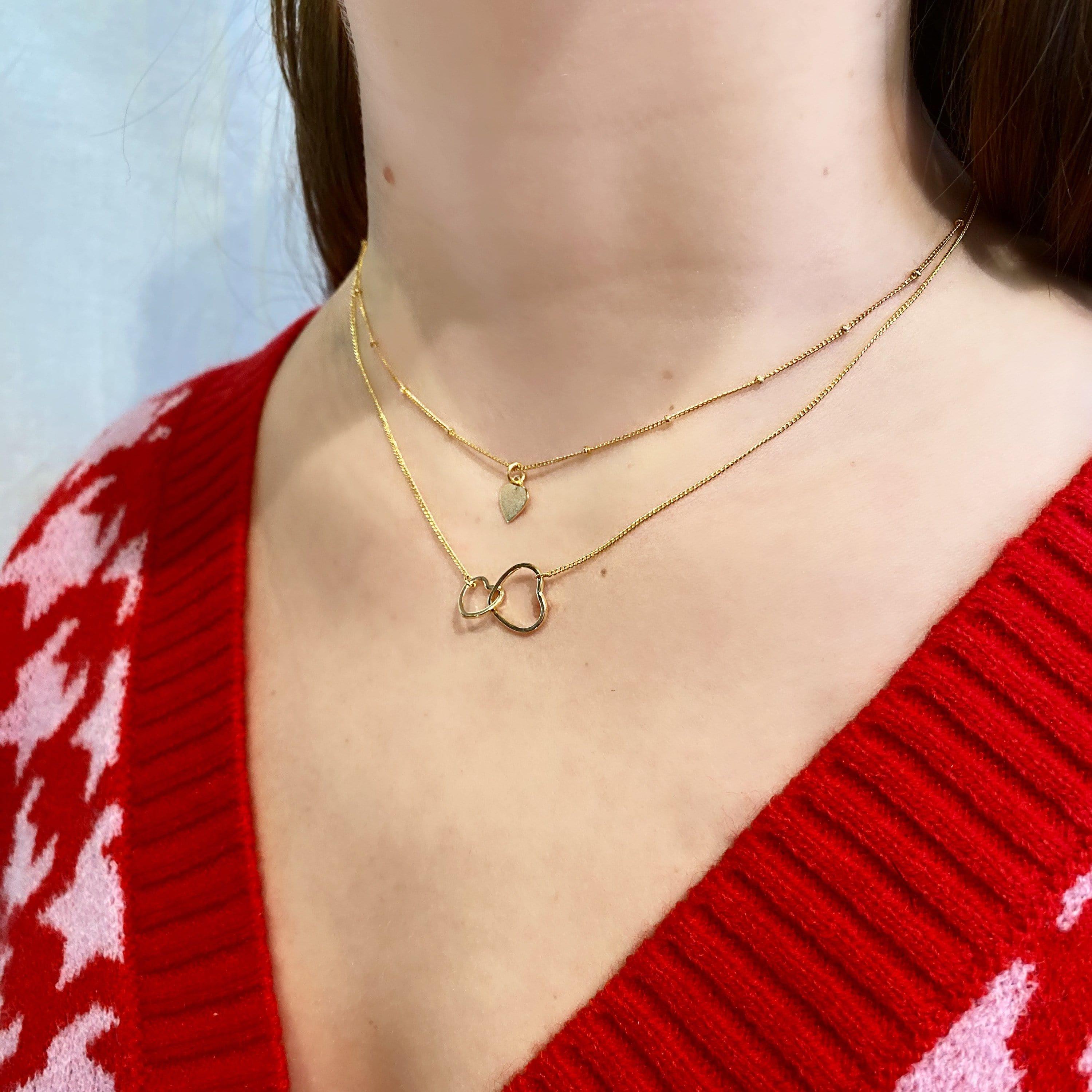 gold plated necklace with heart on model