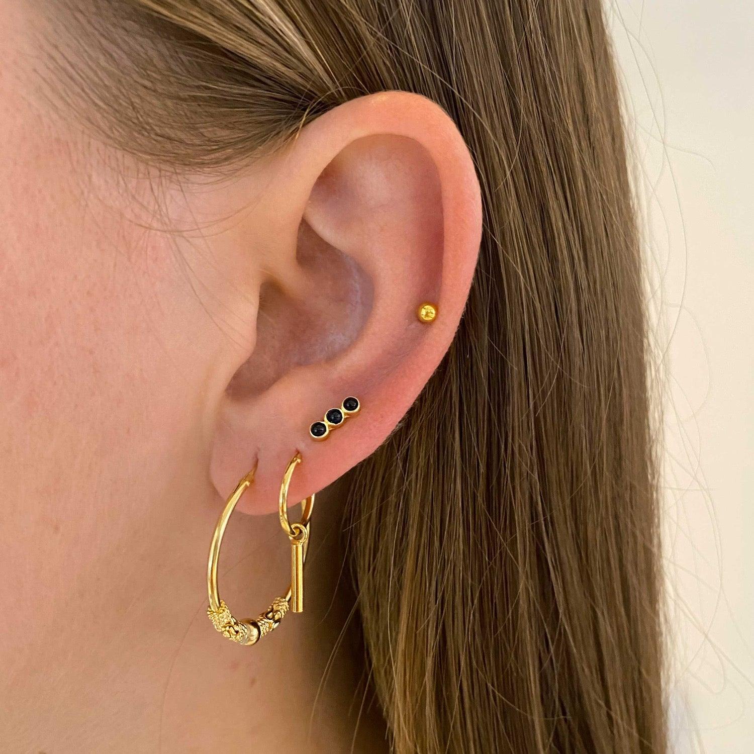 model with 12mm gold plated hoop earrings with long rod