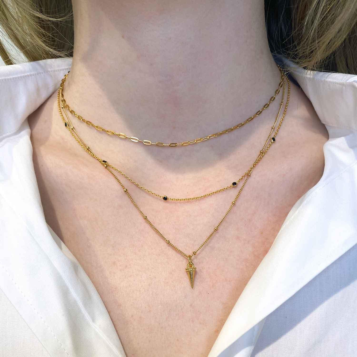gold plated necklace with horn pendant on model