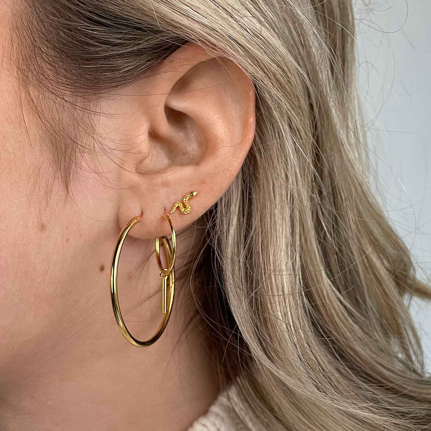 model with gold plated snake earstud